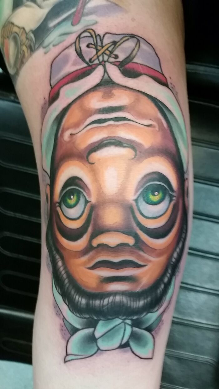 Optical illusion tattoo with a vibrant, eye-bending face design showcasing intricate details and vivid colors.