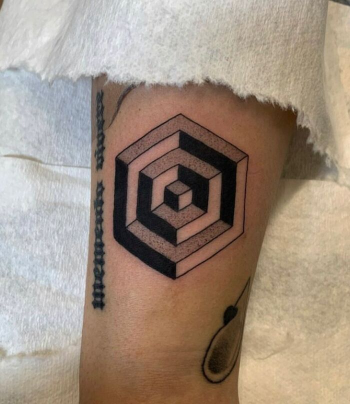 Optical illusion tattoo with geometric hexagon design, creating a mind-bending visual effect.