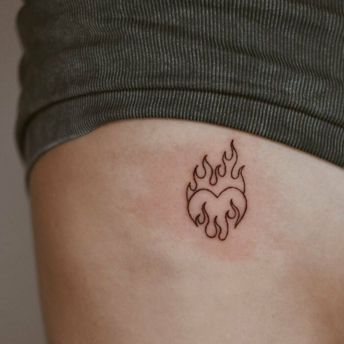 Minimalism enthusiasts will love this unique line tattoo of a heart with flames on the skin.