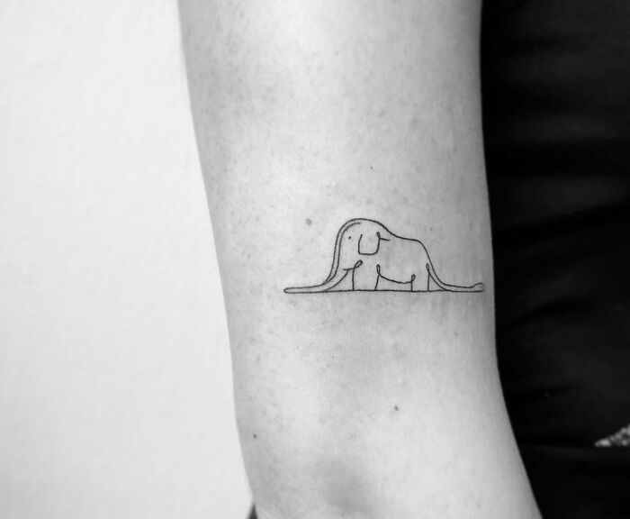 Minimalism enthusiasts line tattoo of an elephant on an arm.