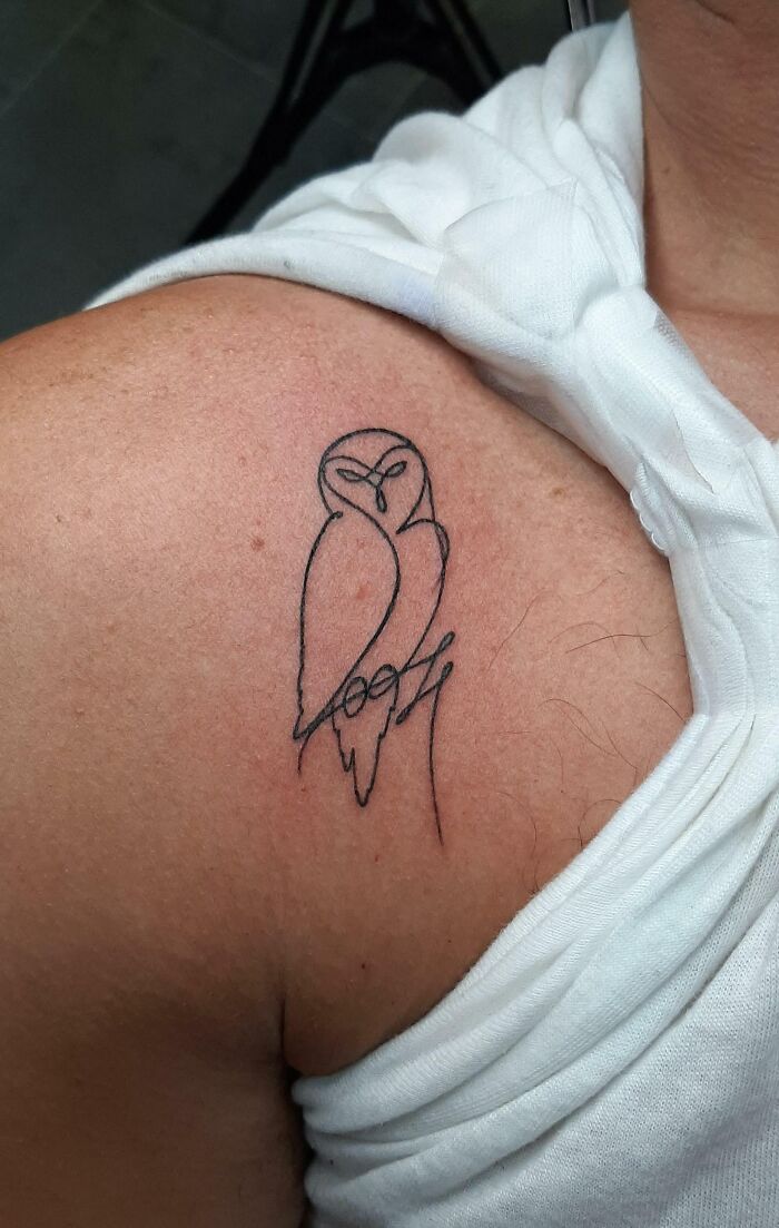 Minimalist owl line tattoo on shoulder, perfect for minimalism enthusiasts and tattoo lovers seeking unique designs.