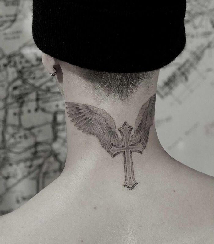 Neck tattoo of wings with a cross, inspired by celebrity tattoos.