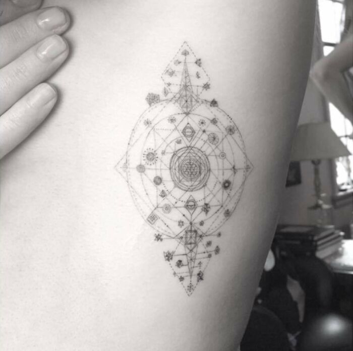 Intricate geometric tattoo design on skin, inspired by celebrity tattoos.