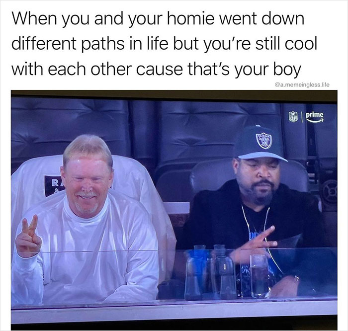 Two men at a sports event, sharing a moment with peace signs, embodying everyday life memes humor.