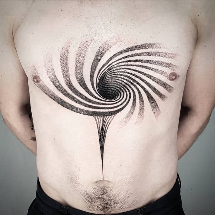 Optical illusion tattoo design on chest with spiral pattern.