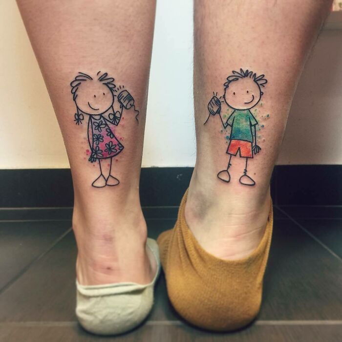 Brother and sister cartoon tattoos on calves, holding string phones, symbolizing connection.