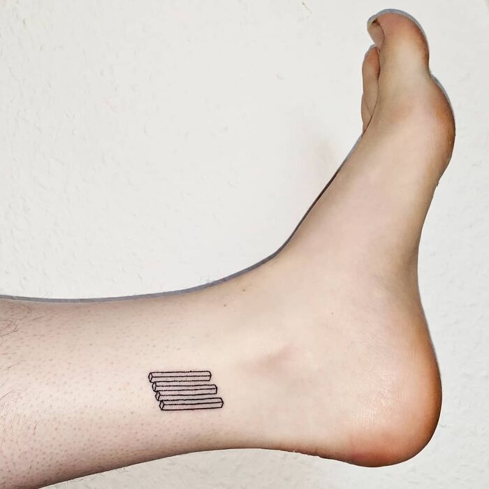 Optical illusion tattoo of penrose stairs on ankle, showcasing minimalist design.