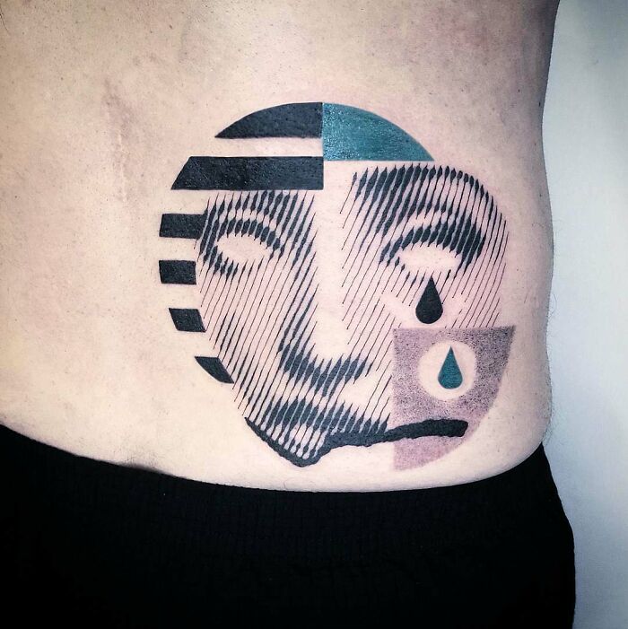 Optical illusion tattoo of a stylized face with geometric patterns and teardrops on skin.