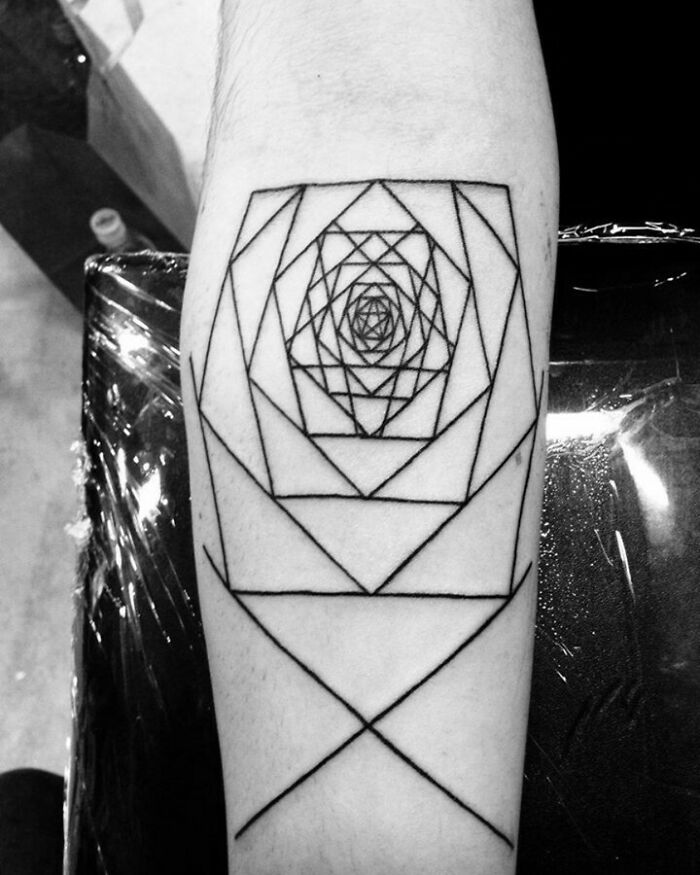 Geometric optical illusion tattoo with intricate line design on forearm.
