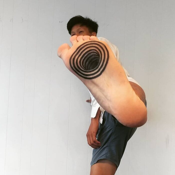 Foot with an optical illusion tattoo, showcasing eye and mind-bending design.