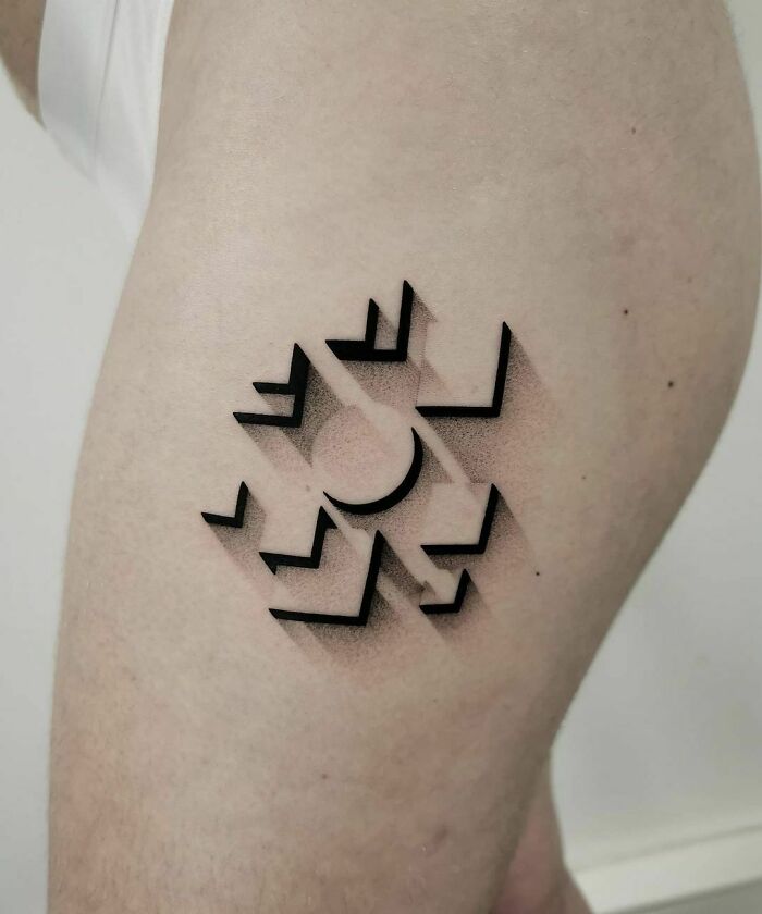 Optical illusion tattoo with geometric shapes on skin, creating a 3D effect.