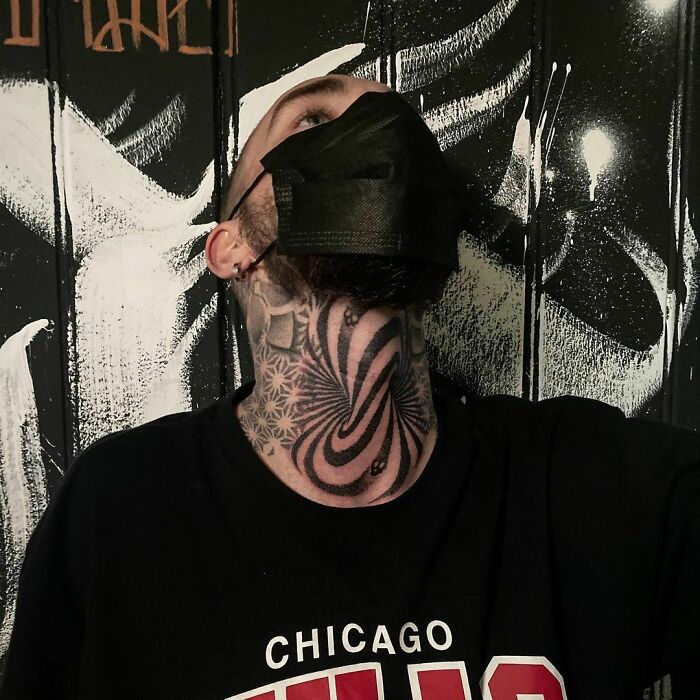 A person with an optical illusion tattoo on their neck, featuring spiral patterns and intricate designs.