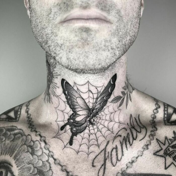 Neck tattoo of a butterfly on a web with "family", showcasing elegant celebrity tattoos.