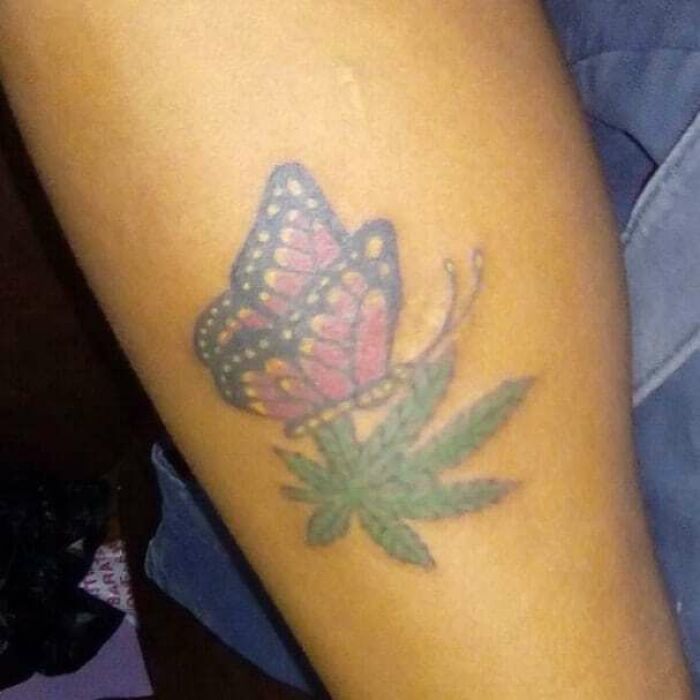 Butterfly and leaf tattoo on a person's arm, showcasing tattoos thought to be less attractive.