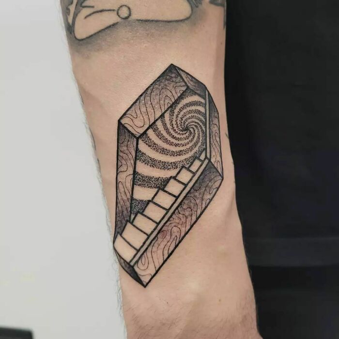 Optical illusion tattoo with spiral staircase design on a forearm, showcasing intricate detail and depth.