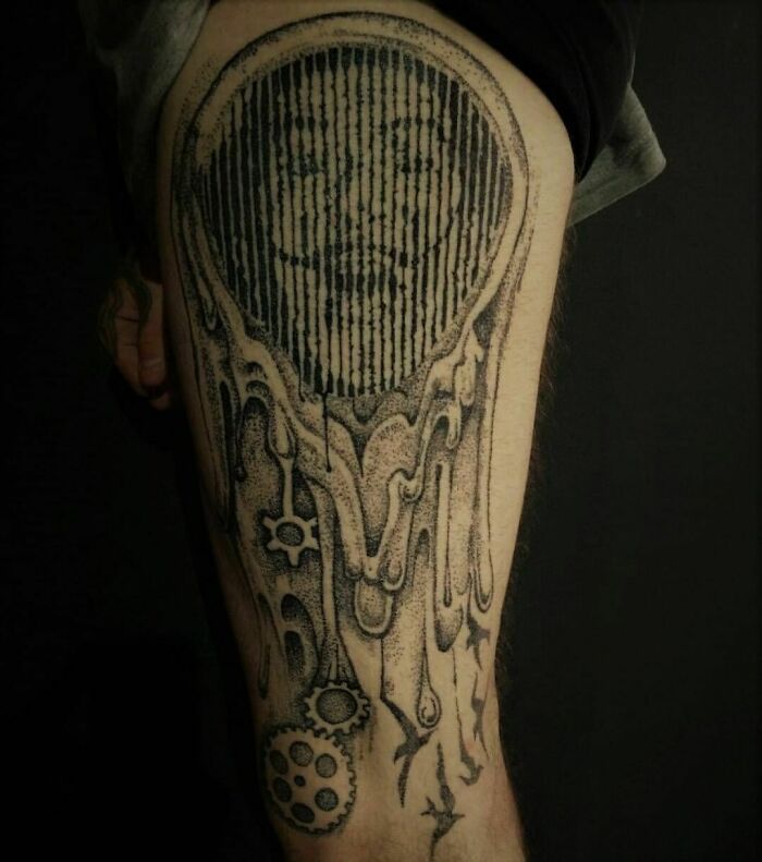 Optical illusion tattoo design featuring a melting face with intricate details on a person's leg.