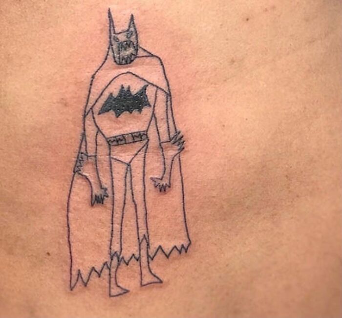Primitive bat-like tattoo sketch on skin, illustrating perceptions of unattractive tattoos.