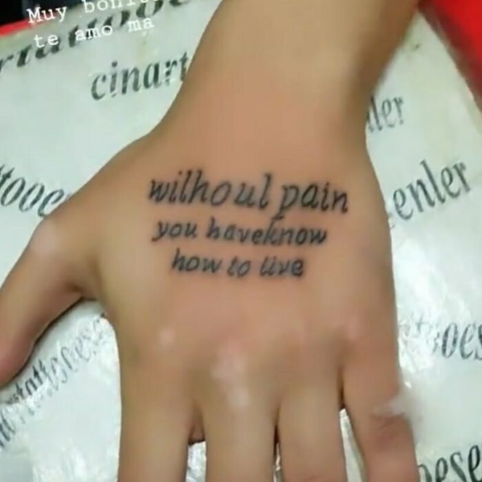 Hand with funny tattoo text featuring misspellings.
