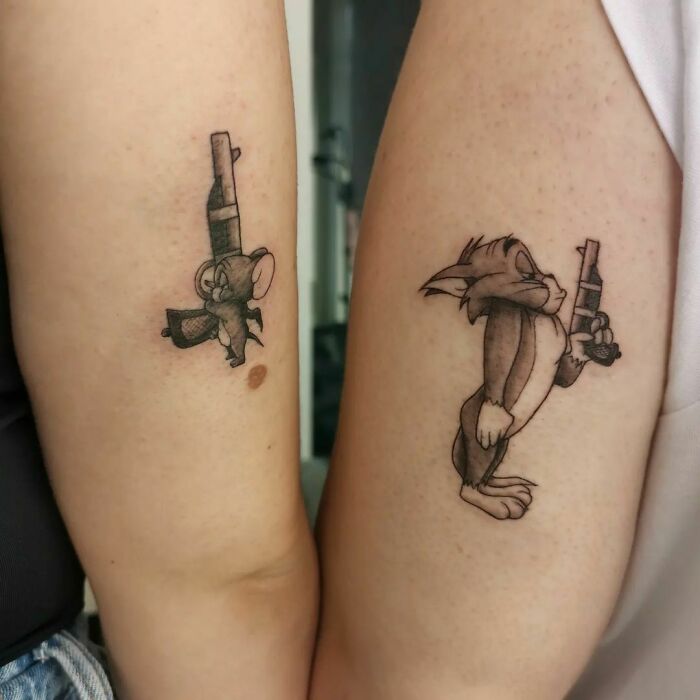 Brother and sister tattoos featuring cartoon characters holding guns on arms.