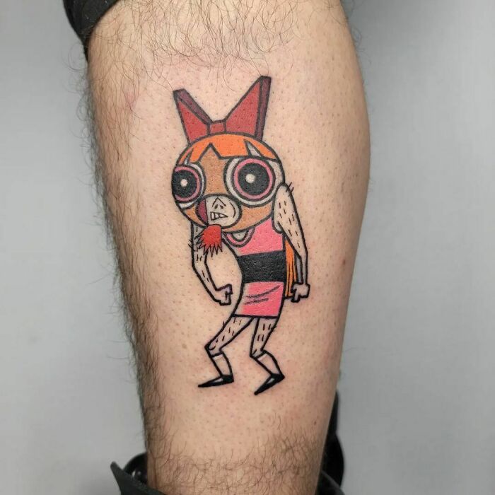 Funny Power Puff Girl tattoo on leg with humorous twist, showcasing a quirky design.