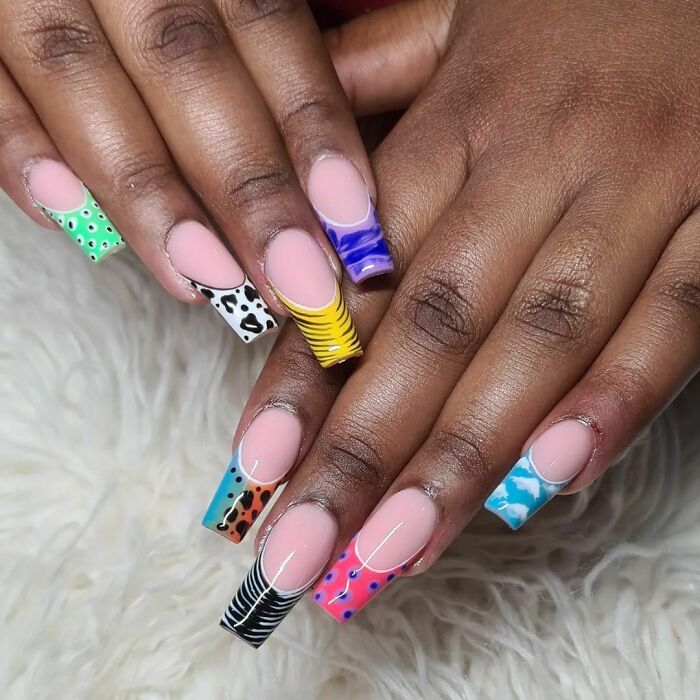 Colorful nail art designs on long nails with diverse patterns showcasing creative nail art ideas.