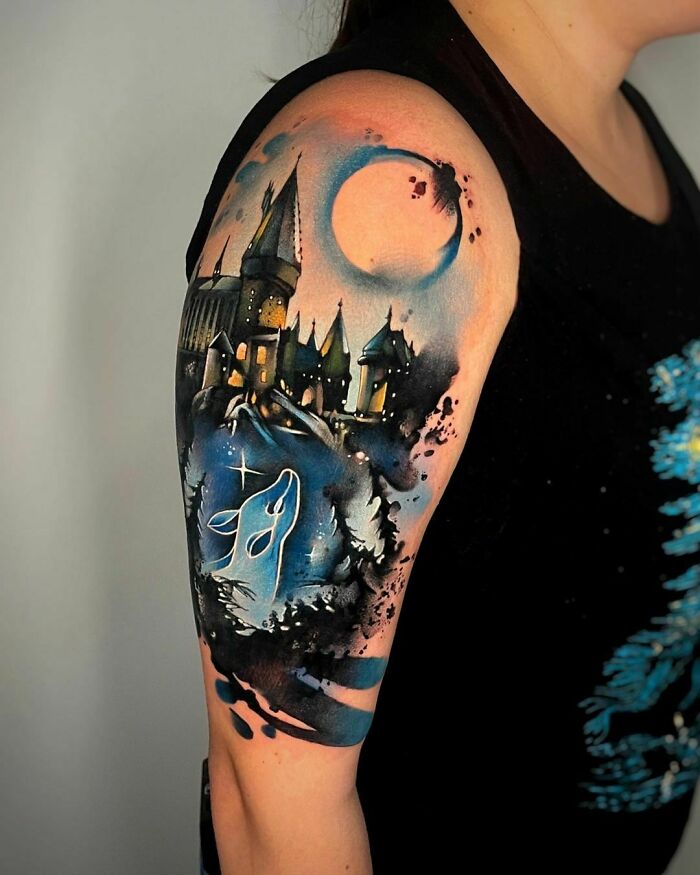 Harry Potter tattoo featuring Hogwarts and a moonlit stag patronus on an arm.