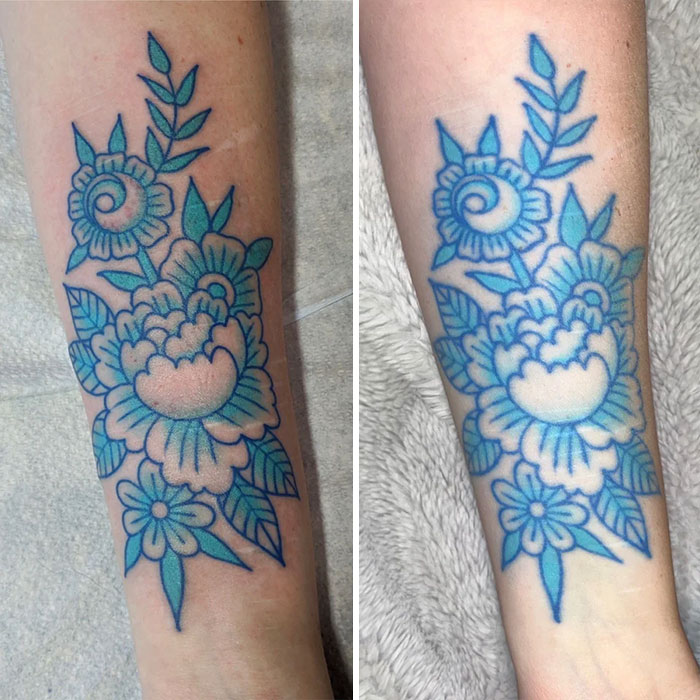 Aged tattoo showing faded blue floral design on forearm, illustrating how ink changes over the years.