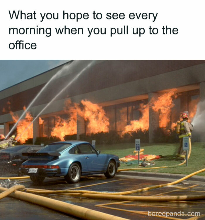 Firefighters spraying water on a burning office building with parked blue car in front, capturing a work week meme.