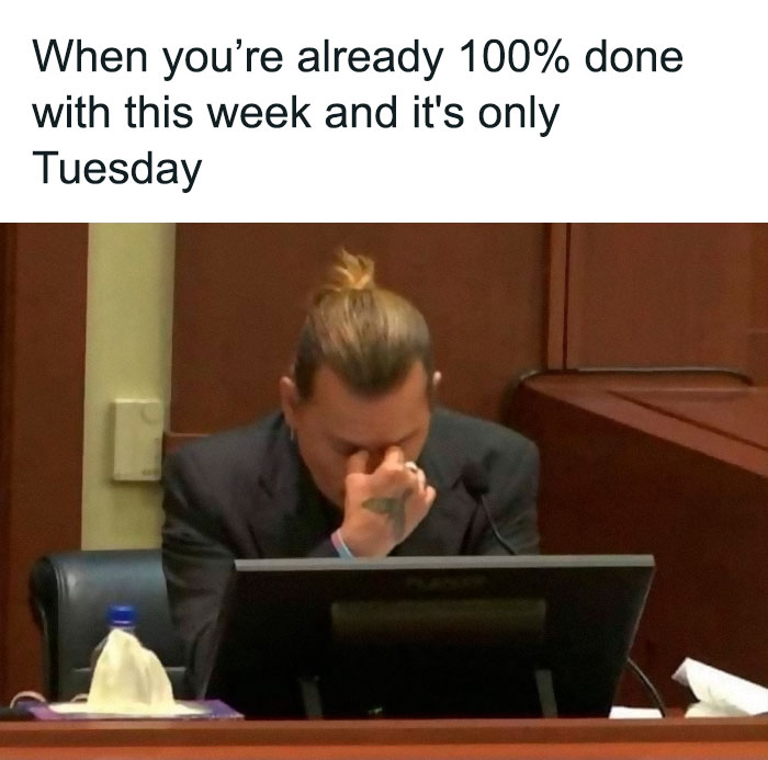 Person looking frustrated in an office setting with text about being overwhelmed on Tuesday, illustrating work week meme.