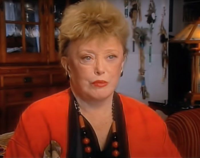 Rue McClanahan wearing an orange sweater and necklace, featured in a discussion about famous people married multiple times.