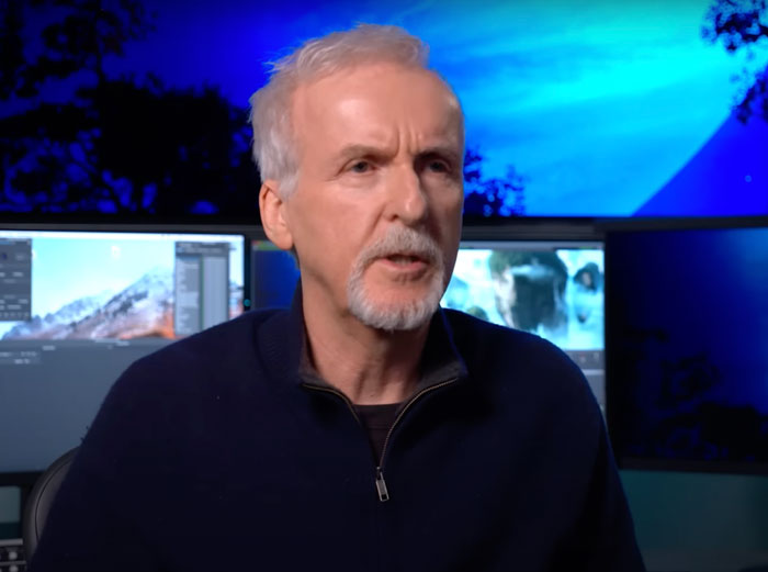 James Cameron wearing dark blue sweater in a studio setting, related to famous people who got married multiple times.