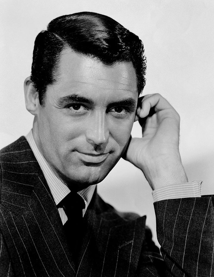 Cary Grant wearing a suit, representing famous people who got married multiple times in classic Hollywood.