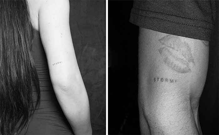 Two arms with tattoos, the word "Stormi" inked on both, showcasing celebrity tattoo ideas.