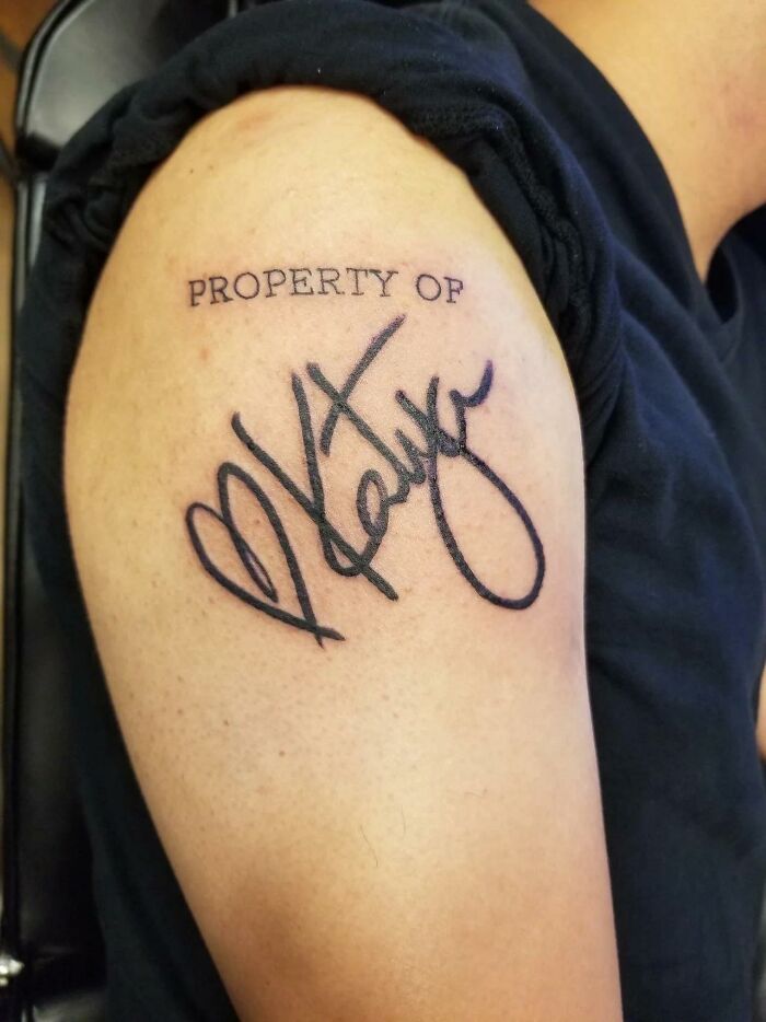 Tattoo reading "Property of Katya" on arm, illustrating an unattractive tattoo style.