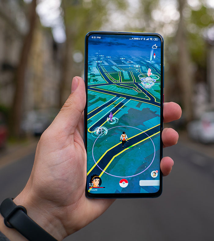 Hand holding smartphone displaying augmented reality game with map, highlighting big trends in technology and gaming.