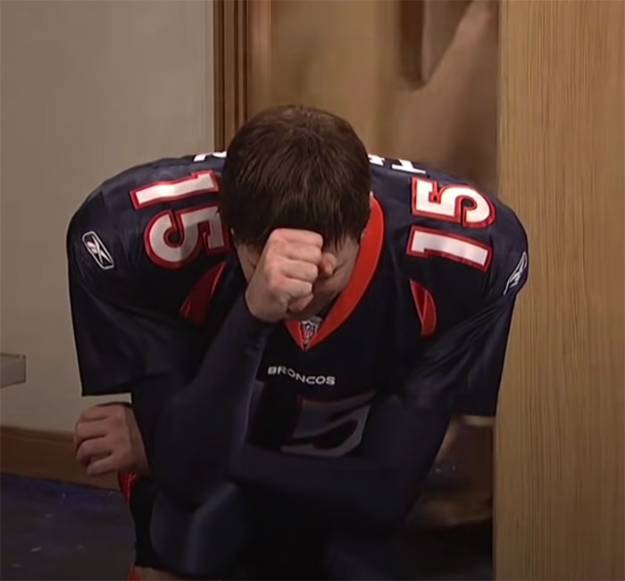 Football player in Broncos uniform kneeling and reflecting, representing big trends from the past almost forgotten over time
