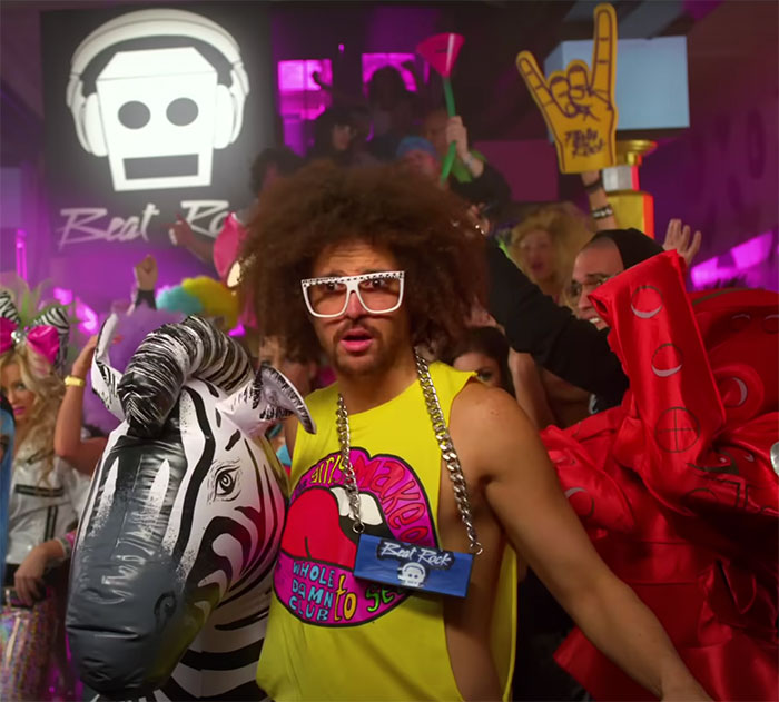 Party scene with people in retro costumes and inflatable props, highlighting big trends that we almost forgot existed.