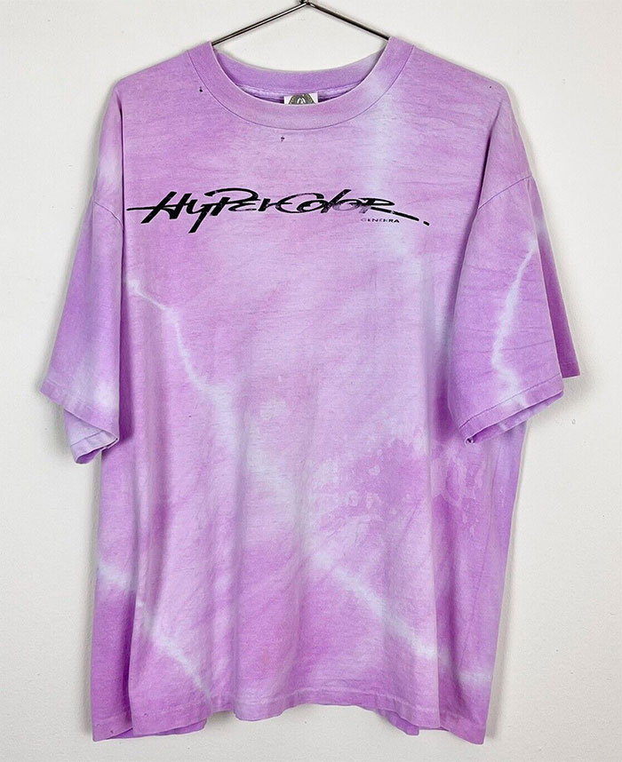 Purple tie-dye shirt with black graphic text, representing big trends from fashion styles we almost forgot existed.