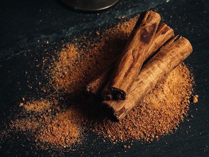 Cinnamon sticks and ground cinnamon spice displayed on a dark surface representing forgotten big trends.