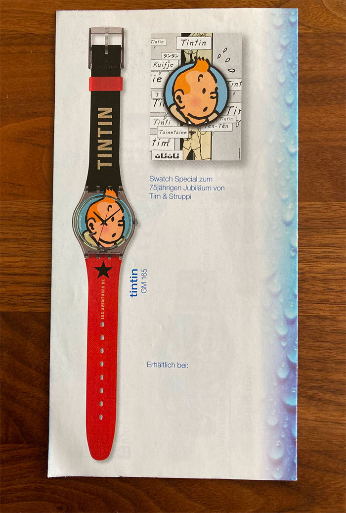 Retro Tintin Swatch watch with character face on dial and red and black strap, showcasing forgotten big trends in collectibles.
