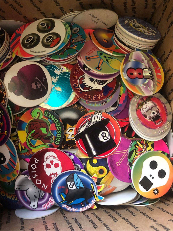 Colorful collection of vintage pogs featuring skulls, cartoons, and retro designs, showcasing big trends we almost forgot.