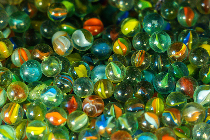 Close-up of colorful glass marbles representing nostalgic big trends in toys and collectibles from the past.