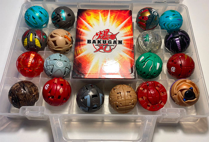 Collection of Bakugan toys displayed in a clear plastic case showcasing nostalgic big trends from the past.