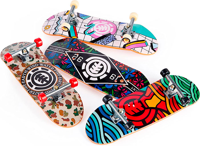 Four colorful skateboards with unique designs showcasing popular big trends in skateboarding culture.
