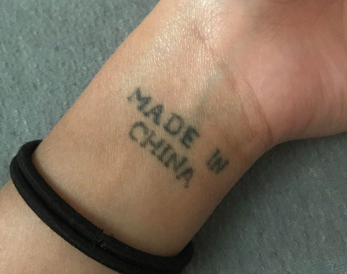 Wrist tattoo with "Made in China" text, showcasing a funny tattoo idea.