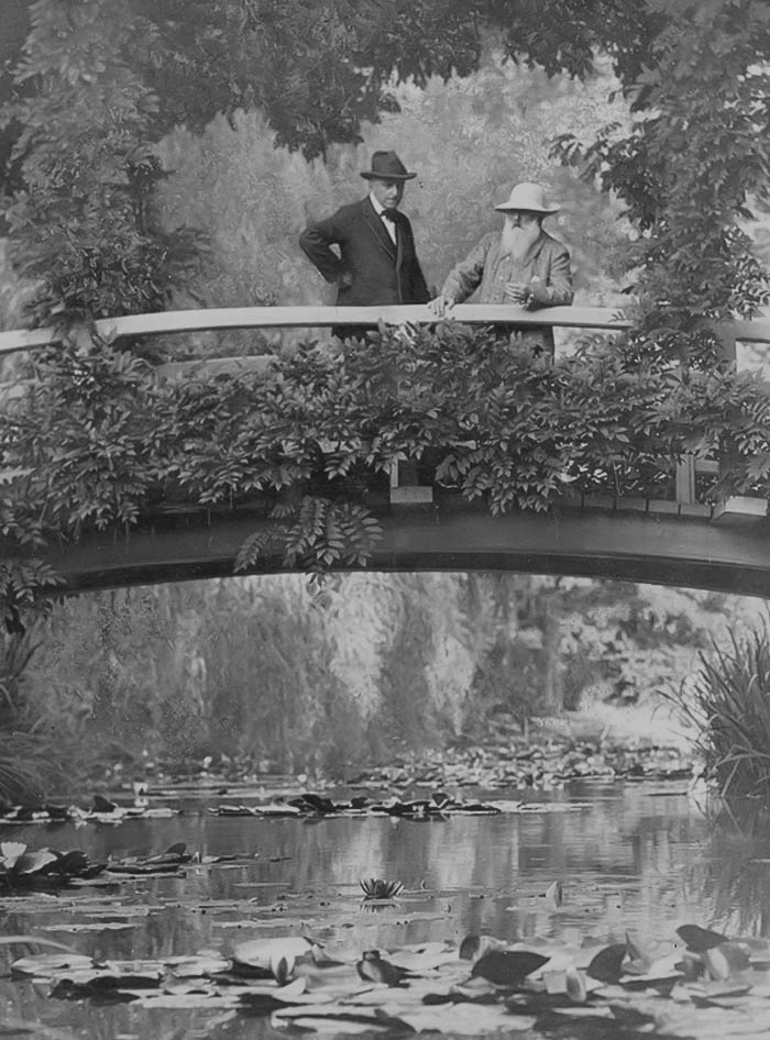 Black and white picture of Claude Monet on the bridge