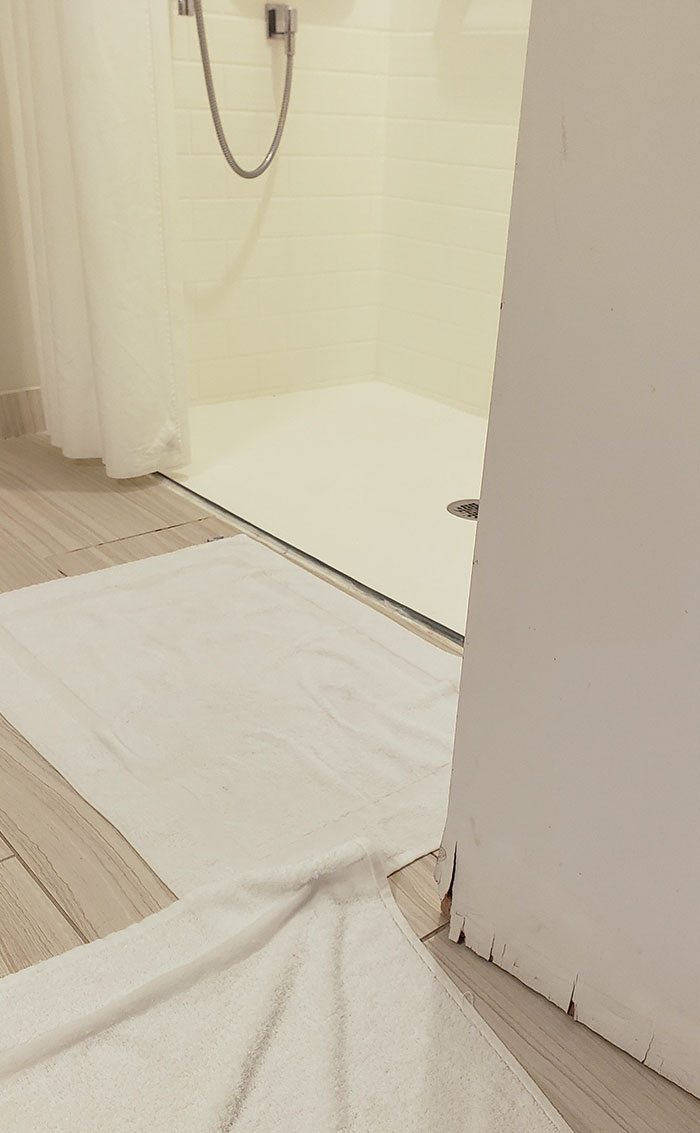 The Hotel Shower Has No Edges, So It Floods, And The Door Has Water Damages