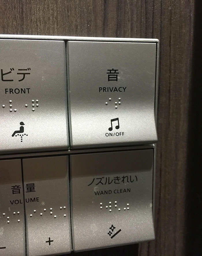 Control panel with Japanese invention features including privacy sound, wand cleaning, and volume buttons with Braille labels.
