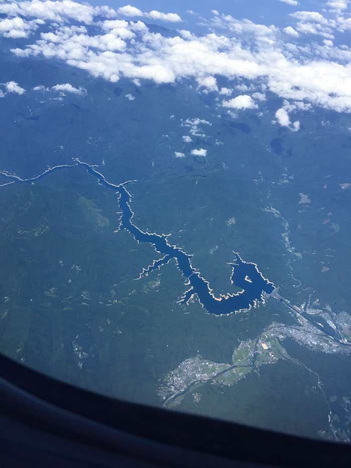 Aerial view of winding river and lush green landscape in Japan showcasing the country like no other unique scenery.