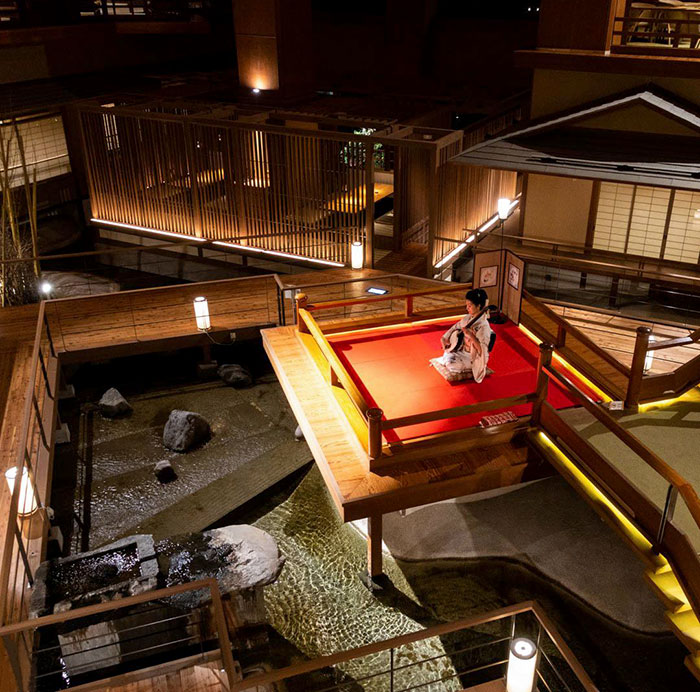 Traditional Japanese architecture and design featuring a serene indoor water garden and seating area showcasing Japanese inventions.